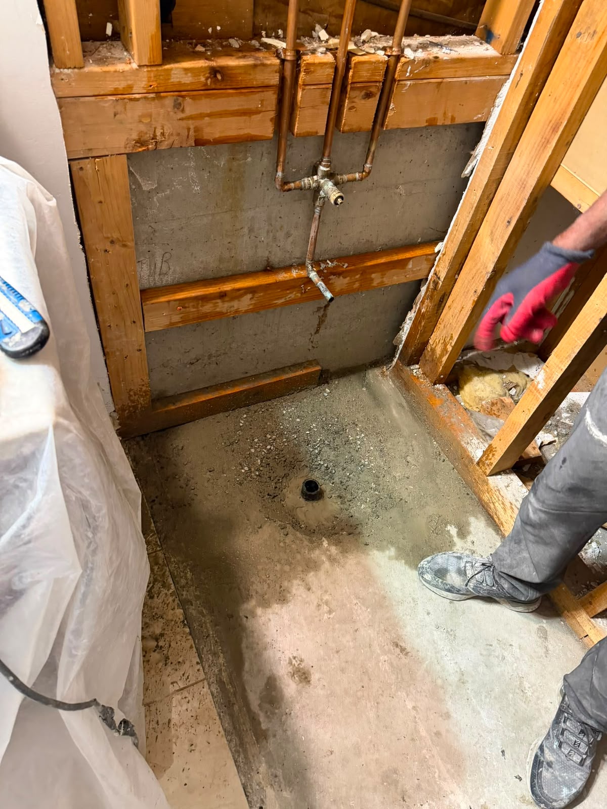 Plumbing rough-in behind the wall before drywall closes it up
